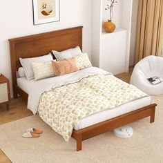 a bed sitting in a bedroom on top of a wooden floor next to a window