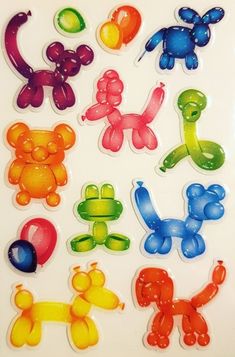 many different colored teddy bears on a white surface