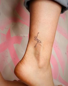 a woman's foot with a small tattoo on it