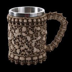 a coffee mug with skulls on it is shown in the shape of a human skull