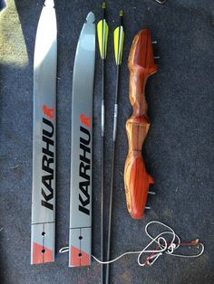 some skis are laying on the ground next to other items that have been placed around them