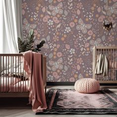 a baby's room with floral wallpaper and a crib in the foreground