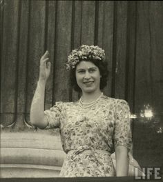 an old black and white photo of a woman waving