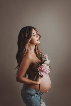 a pregnant woman holding flowers in her stomach