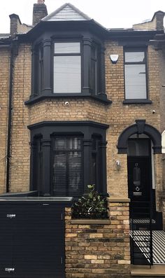 a brick house with black doors and windows