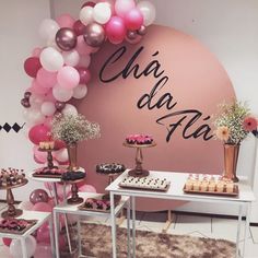 the dessert table is decorated with pink, white and gold balloons that spell out oh la la