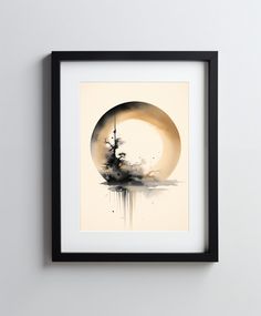 a black and white painting hanging on a wall next to a framed object with the moon behind it