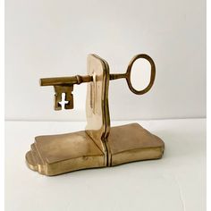 an antique brass key holder with a magnifying glass on it's side