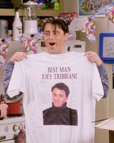 a man holding up a t - shirt that says best man, joey tribbiani