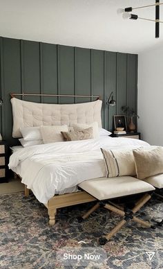 a large bed sitting on top of a wooden floor next to a wall mounted clock