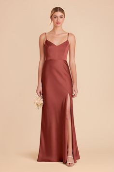 a bridesmaid in a long, spaghetti - neck dress with slits on the side