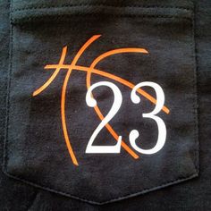 an orange and white logo on the back of a pair of black sweatpants that reads 23