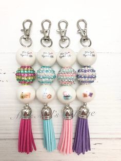 the keychain is decorated with beads and tassels, which are attached to each other