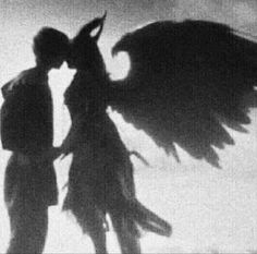 two people standing next to each other with wings