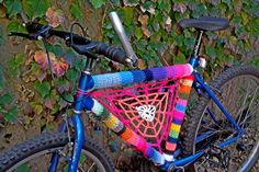 a colorful bicycle parked in front of a green wall