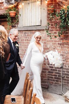 a bride and groom walking down the aisle after their wedding ceremony in an alleyway