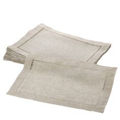 two linen placemats on a white surface