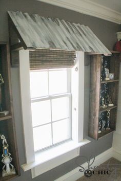 a window in the corner of a room with shelves on either side and a metal roof over it