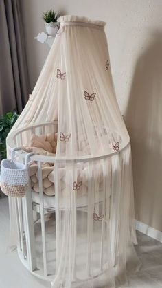 a baby crib with a mosquito net over it