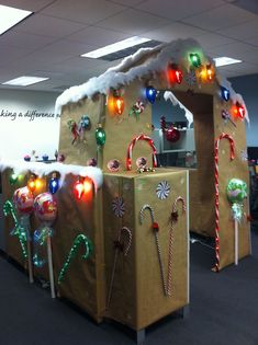 an office cubicle decorated for christmas with candy canes and candies on display