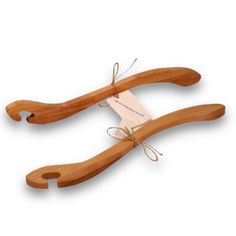 two wooden hangers with tags attached to them