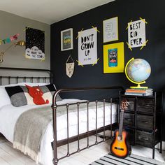 a bed room with a neatly made bed and pictures on the wall