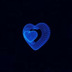 a heart shaped object in the dark with blue light shining on it's side