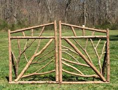 a wooden gate made out of sticks in the grass