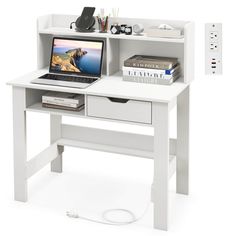 a laptop computer sitting on top of a white desk next to a book shelf and power strip