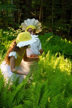 two people in the woods with flowers on their heads