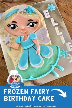 a frozen fairy birthday cake on a wooden table