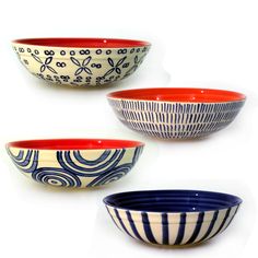 three bowls with different designs on them sitting next to each other in front of a white background