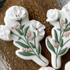 two decorated cookies sitting on top of a table