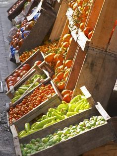 several wooden boxes filled with different types of fruits and vegetables