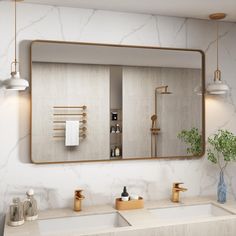 a bathroom with marble counter top and gold framed mirror over the sink, along with brass faucets