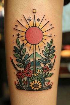 a tattoo with flowers and plants on it