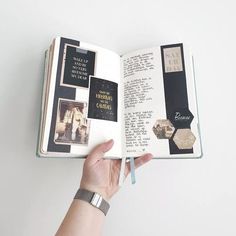 a hand holding an open book with pictures on the pages and words written in it