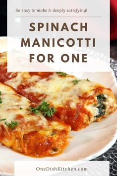 spinach manicotti for one on a white plate with text overlay that says spinach manicotti for one