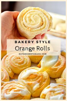 an orange roll is being held up by someone's hand with the words bakery style orange rolls on it