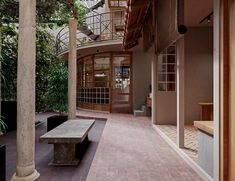 the inside of a building with columns and benches