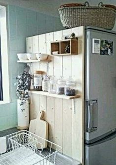 a refrigerator freezer sitting inside of a kitchen next to a window