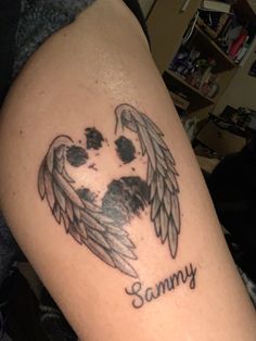 a dog's paw with an angel wings tattoo on its arm that says, sammy