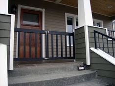 the front steps of a house with a wooden door