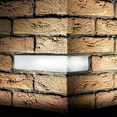 a light that is on in the side of a brick wall