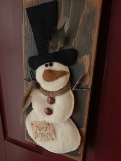 a snowman hanging on the side of a door