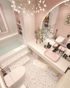 a bathroom with pink walls and white fixtures