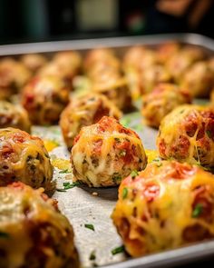 baked meatballs with cheese and tomato sauce on a baking sheet