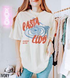 Introducing our "Pasta Club" Shirt, a stylish must-have for those who live for good food and good vibes. We use professional quality DGT printing on all our apparel. Direct-to-garment, or DTG, is a high quality printing method that sprays ink directly onto the garment so there is no peeling or cracking. This fabulous graphic will be printed on a Comfort Colors Unisex T-Shirt. Please refer to the size charts in the images for the best fit.  Estimated Production Time: 1-5 days Estimated Shipping Time: 2-5 days 100% cotton shirt  Machine wash: cold  Non-chlorine: bleach as needed Tumble dry: low heat Iron, steam or dry: medium heat Do not dry clean Italian Graphics, Pasta Shirt, Pasta Lover, Retro Graphic Tees, Club Shirts, Vintage Aesthetic, Size Charts, Food Lover, Comfort Colors