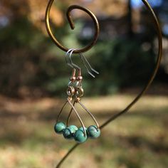 These earrings feature turquoise beads and brass wire in a "coat hanger" pattern. They are only one inch long. Surgical steel hooks. One Inch, Coat Hanger, Turquoise Beads, Beading, Etsy Earrings, Beauty Book, Accessory Gift, Display Homes, Electronic Accessories