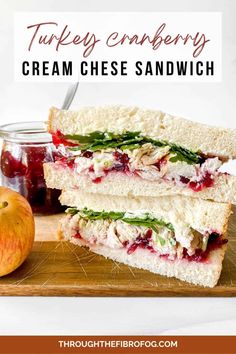 turkey and cranberry cream cheese sandwich on a cutting board